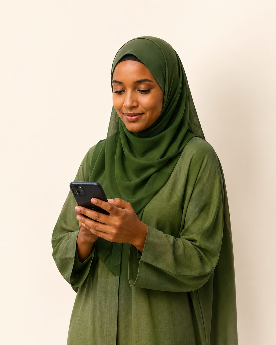 A young Somali professional using ShaqoSmart on her phone
